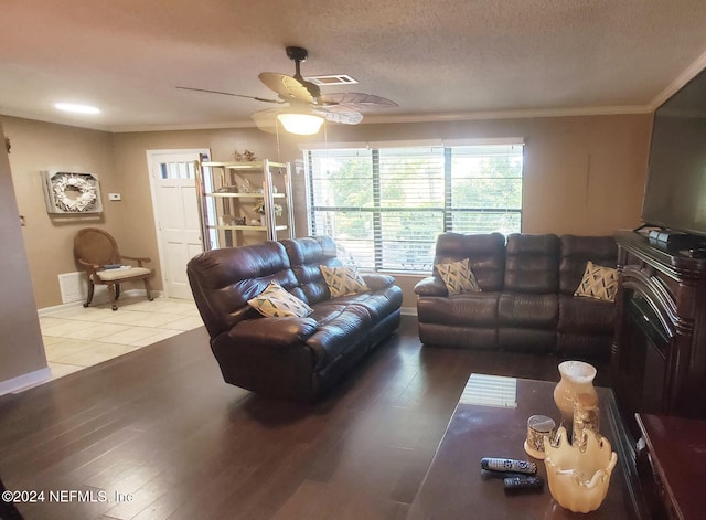 living room with crown molding, a textured ceiling, hardwood / wood-style flooring, and ceiling fan