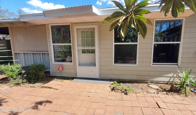 property entrance with a patio area