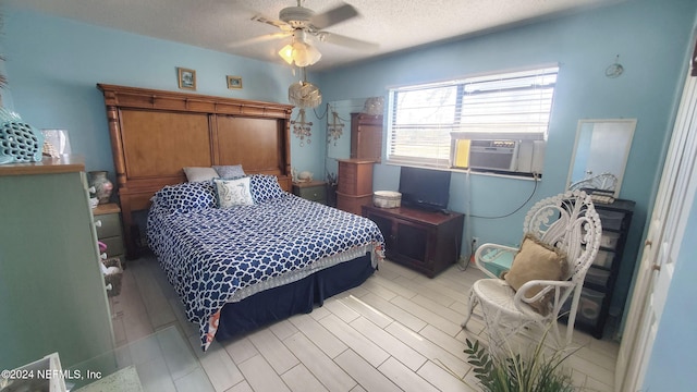 bedroom featuring ceiling fan, cooling unit, a textured ceiling, and light hardwood / wood-style floors