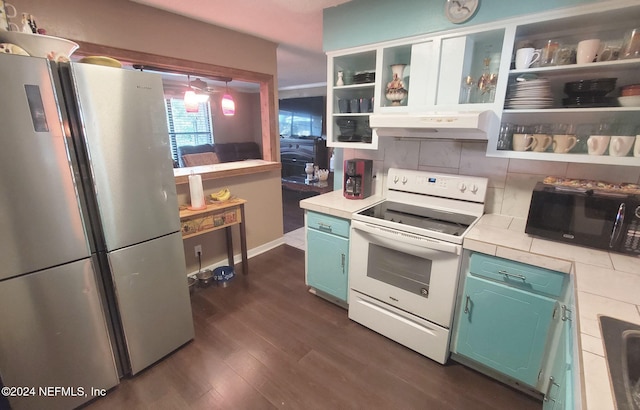 kitchen featuring tasteful backsplash, stainless steel fridge, decorative light fixtures, white range with electric stovetop, and dark wood-type flooring