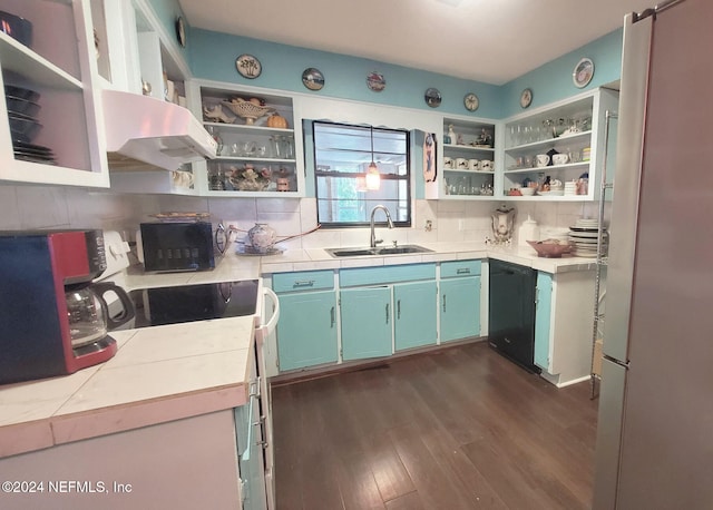 kitchen with tile counters, range hood, sink, black appliances, and dark hardwood / wood-style flooring