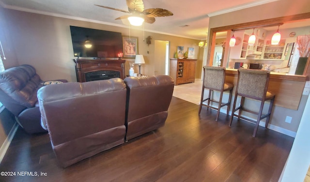 living room featuring crown molding, dark hardwood / wood-style floors, and ceiling fan