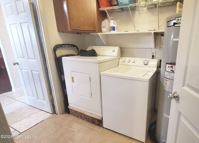 laundry area featuring independent washer and dryer, light tile patterned flooring, cabinets, and water heater