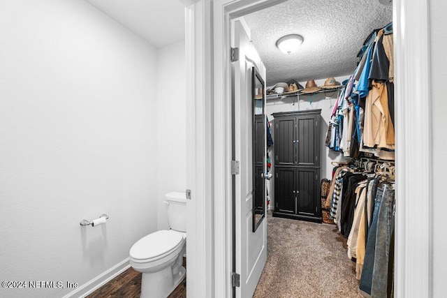 bathroom with a textured ceiling and toilet