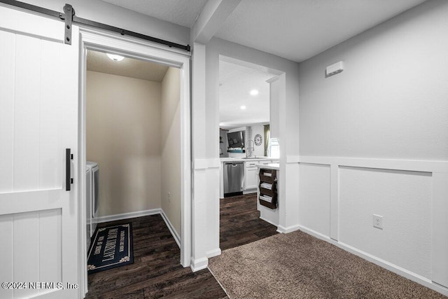 hall with sink, dark hardwood / wood-style floors, and a barn door