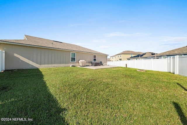 back of house featuring a patio and a lawn