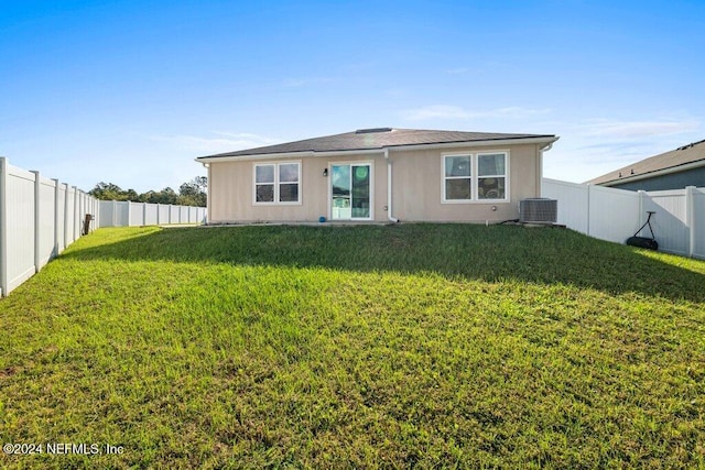 rear view of property with a lawn