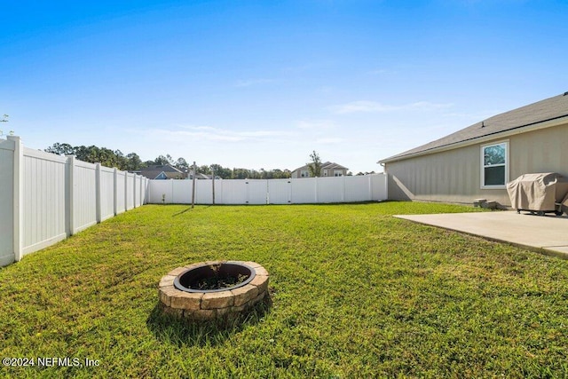 view of yard with a patio area and a fire pit