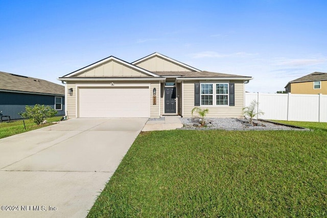 view of front of house with a garage and a front yard