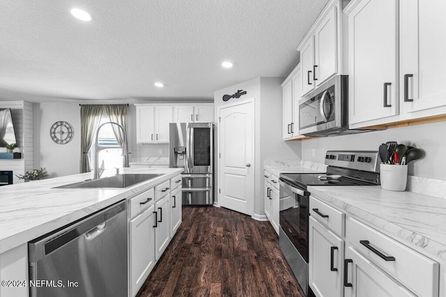 kitchen with white cabinetry, sink, and stainless steel appliances