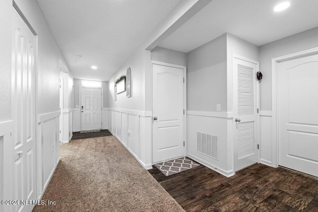 hallway with dark hardwood / wood-style flooring