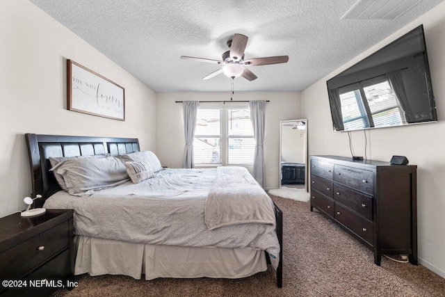 bedroom featuring light carpet, ceiling fan, and a textured ceiling