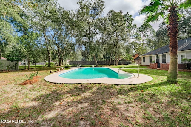 view of swimming pool featuring a diving board and a yard