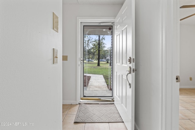 doorway featuring light tile patterned flooring