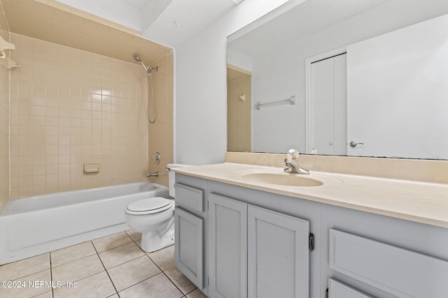 full bathroom with toilet, vanity, tiled shower / bath, and tile patterned flooring