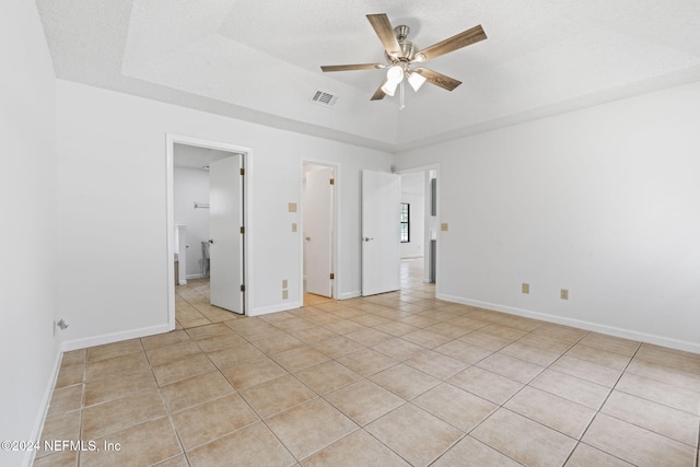 unfurnished bedroom featuring a textured ceiling, light tile patterned floors, and ceiling fan