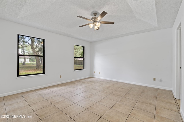 spare room featuring a wealth of natural light and a textured ceiling