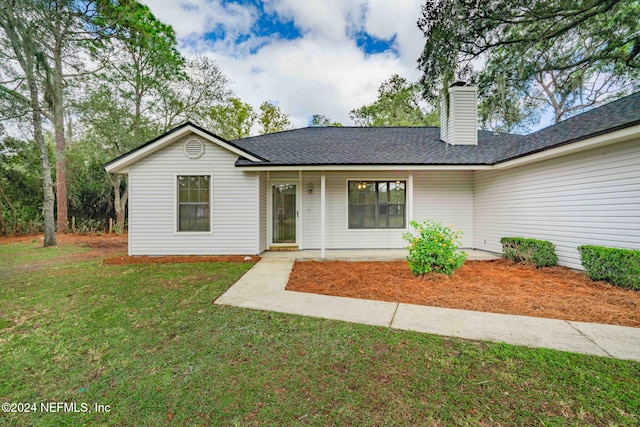 single story home featuring a front yard