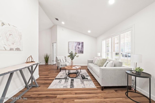 living room featuring recessed lighting, wood finished floors, baseboards, and high vaulted ceiling