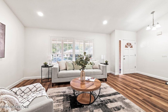 living area featuring recessed lighting, baseboards, an inviting chandelier, and wood finished floors