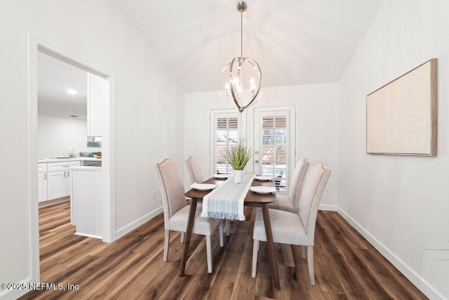 dining space featuring baseboards, lofted ceiling, an inviting chandelier, and dark wood-style floors