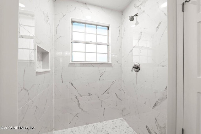 bathroom featuring tiled shower