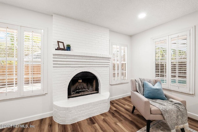 living area featuring wood finished floors, baseboards, and a wealth of natural light