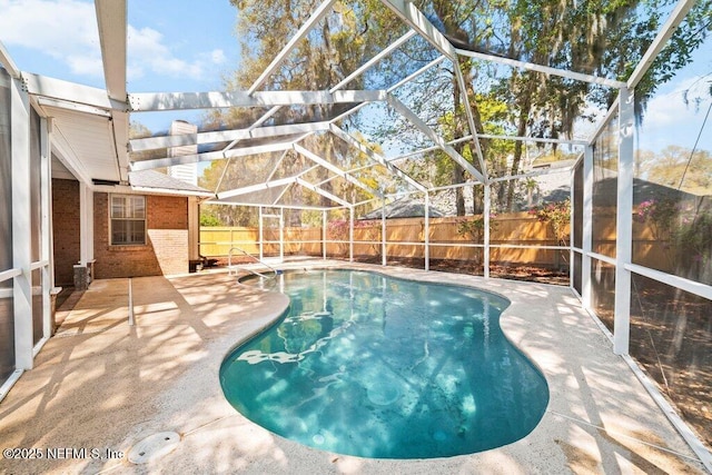 view of pool with a lanai, a fenced in pool, a patio, and a fenced backyard