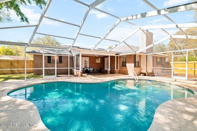 view of pool featuring a fenced in pool, a patio, a fenced backyard, and glass enclosure