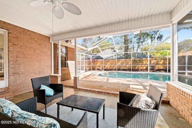 view of patio with a lanai, a fenced in pool, a fenced backyard, and a ceiling fan