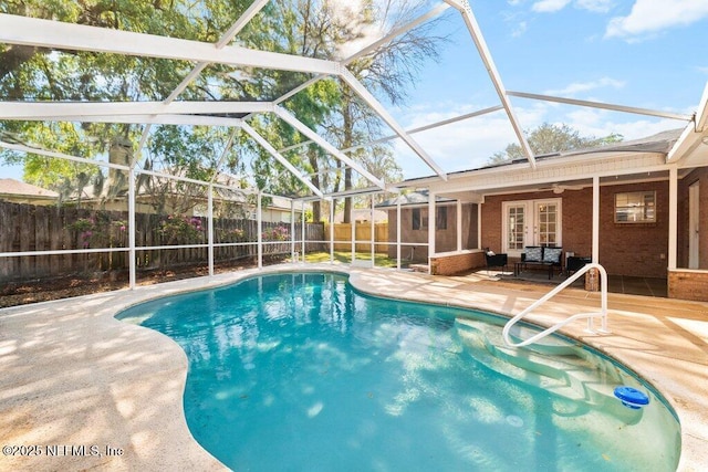 view of pool with a fenced backyard, french doors, glass enclosure, a fenced in pool, and a patio area