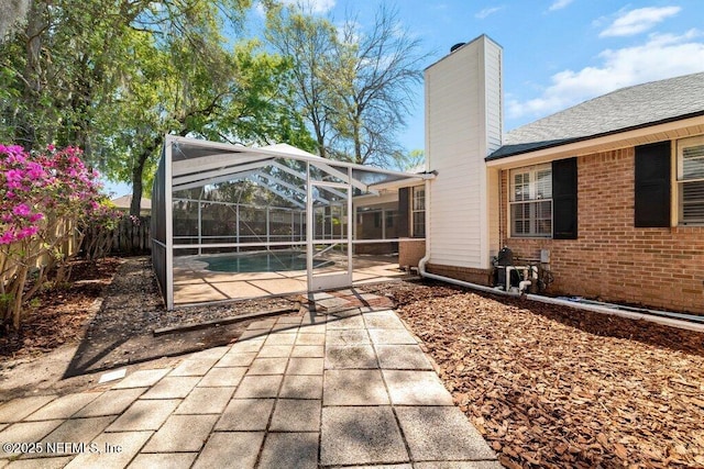 view of patio / terrace with a lanai, a fenced backyard, and a fenced in pool