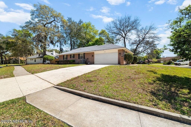 ranch-style house with central air condition unit, a front lawn, concrete driveway, and an attached garage