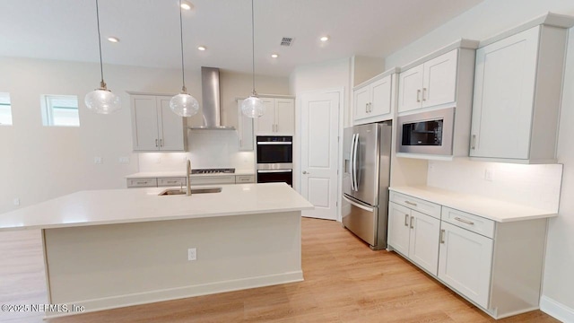 345 Palomar Dr, Saint Johns, FL 32259 - kitchen with stainless steel refrigerator with ice dispenser, wall chimney exhaust hood, double wall oven, built in microwave, and decorative light fixtures