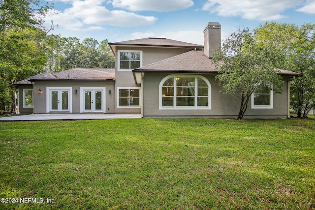 rear view of house with french doors, a yard, and a patio area