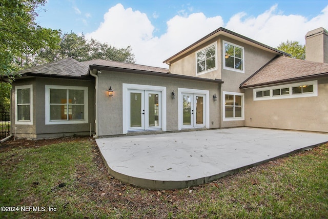 2693 Seneca Dr, Saint Johns, FL 32259 - rear view of house with french doors, stucco siding, a patio, a chimney, and a shingled roof