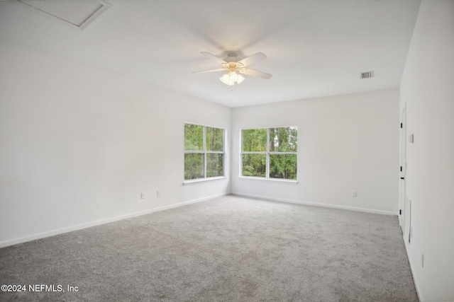 carpeted spare room featuring ceiling fan