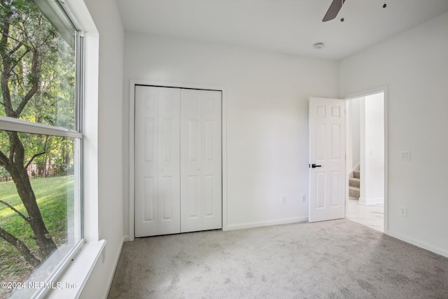 2693 Seneca Dr, Saint Johns, FL 32259 - unfurnished bedroom with carpet flooring, a closet, baseboards, and ceiling fan