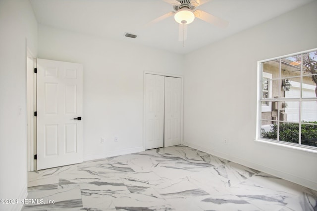 unfurnished bedroom featuring multiple windows, a closet, and ceiling fan