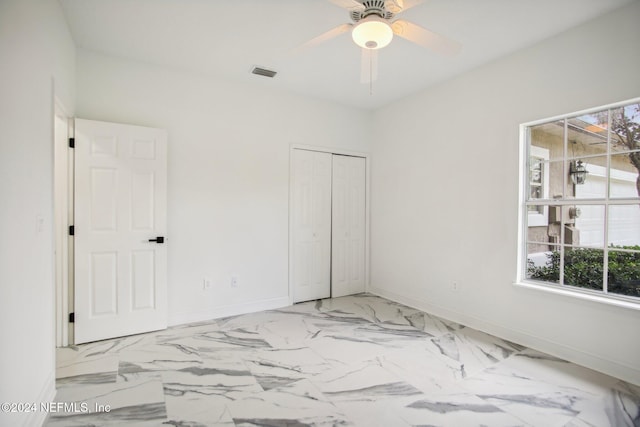 2693 Seneca Dr, Saint Johns, FL 32259 - unfurnished bedroom featuring baseboards, a closet, ceiling fan, and light marble finish flooring