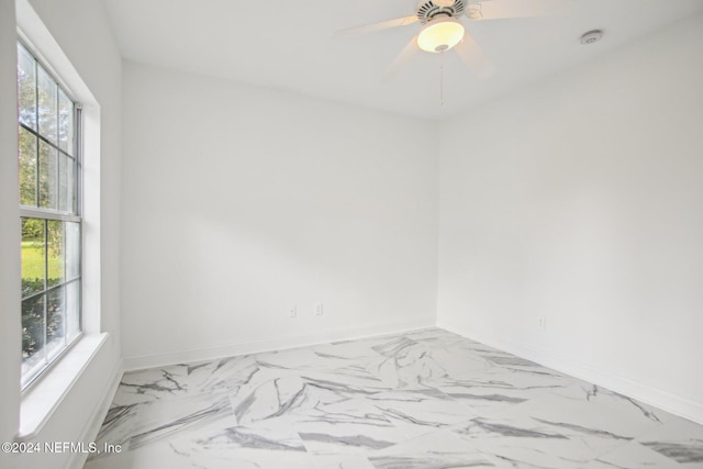 2693 Seneca Dr, Saint Johns, FL 32259 - empty room featuring marble finish floors, baseboards, and ceiling fan