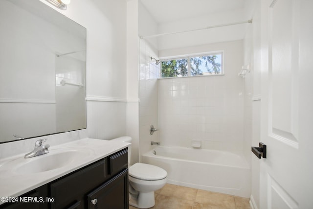 full bathroom featuring vanity, tiled shower / bath, toilet, and tile patterned flooring