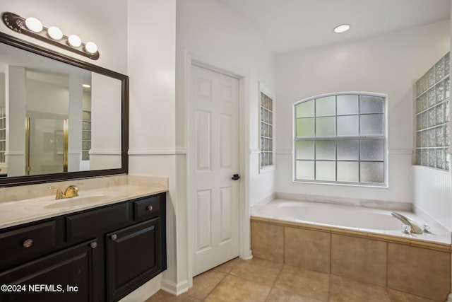 bathroom with vanity, plus walk in shower, and tile patterned flooring