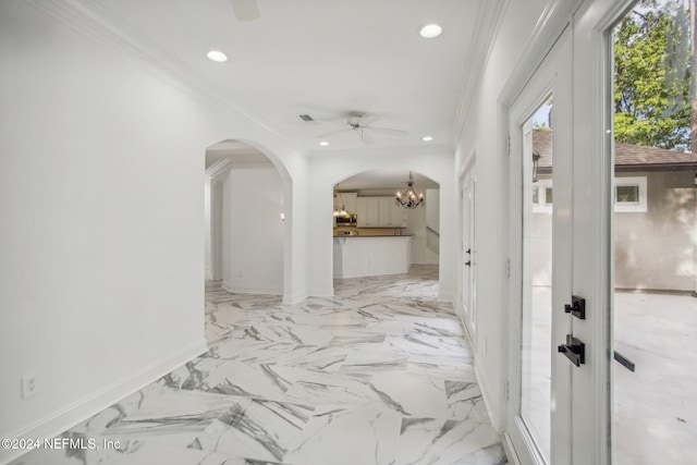 corridor featuring crown molding and a notable chandelier