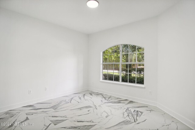 2693 Seneca Dr, Saint Johns, FL 32259 - spare room featuring baseboards and marble look tiles