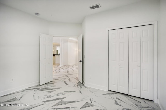 2693 Seneca Dr, Saint Johns, FL 32259 - unfurnished bedroom with marble look tile flooring, baseboards, and a closet