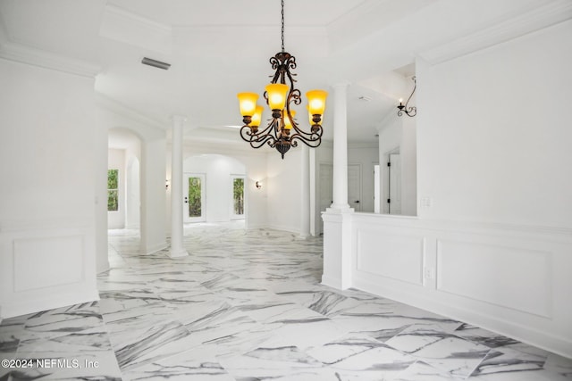 dining room with decorative columns, ornamental molding, and a chandelier