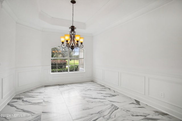 2693 Seneca Dr, Saint Johns, FL 32259 - spare room with a chandelier, ornamental molding, a decorative wall, a tray ceiling, and light marble finish floors