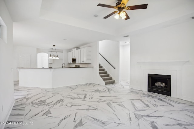 living room featuring sink and ceiling fan