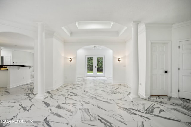 spare room featuring crown molding, ornate columns, a tray ceiling, and french doors